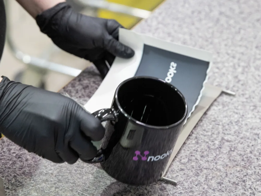 Branded mug being packaged